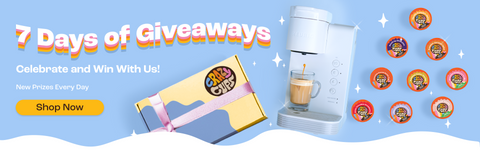 7 days of giveaways banner, with a photo of a white keurig machine, crazy cup pods, and a gift box against a blue background, with the subtitles "celebrate and win with us!" and "new prizes every day," as well as a yellow "shop now" button.